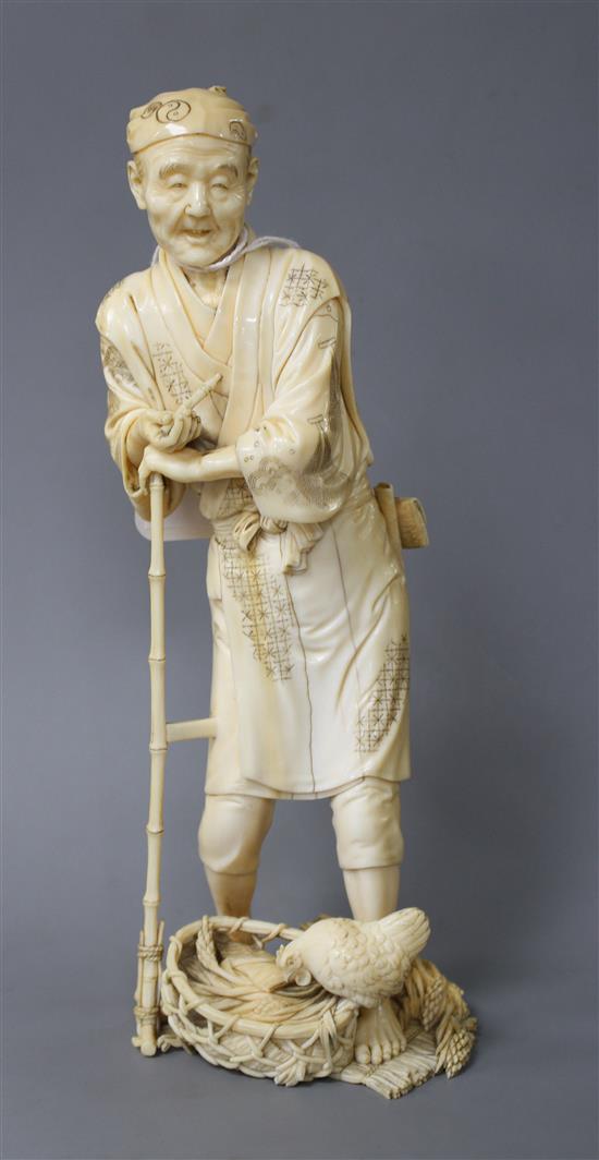 A Japanese Tokyo School ivory okimono, carved as a farmer above a chicken, Meiji period, signed, 24cm